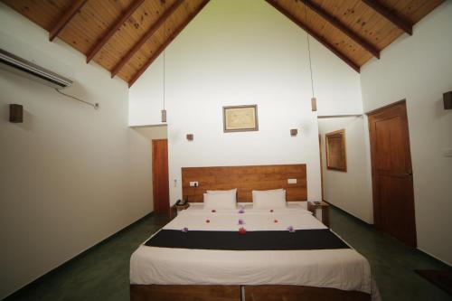 a bedroom with a large bed in a room at Miracle Resorts & Villas in Polonnaruwa