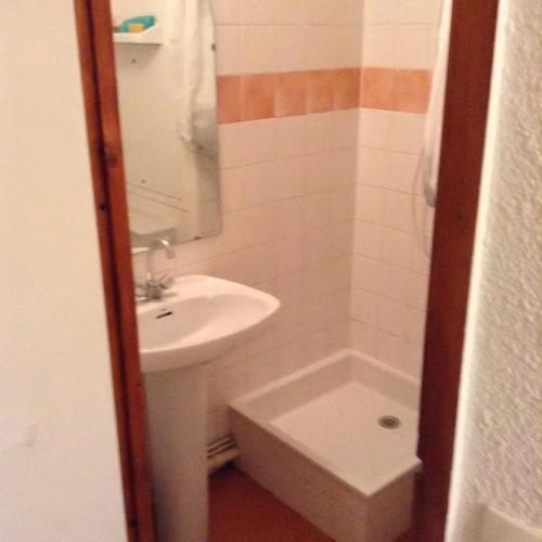 a bathroom with a sink and a toilet and a mirror at Les studios du chalet club Valfréjus in Modane