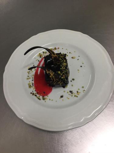 a white plate with a dessert on it at Panorama Hotel in Siracusa