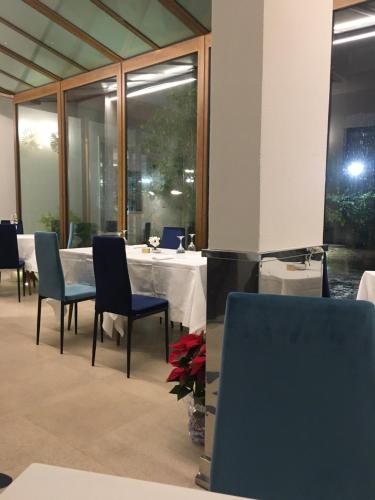 a dining room with a table and chairs at Panorama Hotel in Siracusa