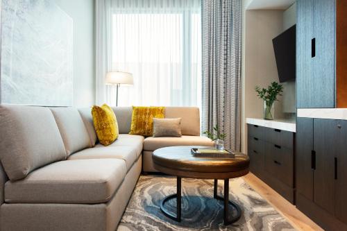a living room with a couch and a coffee table at Kimpton Hotel Arras by IHG in Asheville