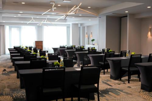 a row of tables and chairs in a room at Glover Park Hotel Georgetown in Washington