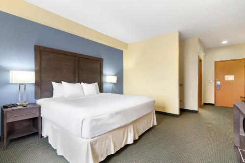a large white bed in a hotel room at Days Inn by Wyndham Ellensburg in Ellensburg