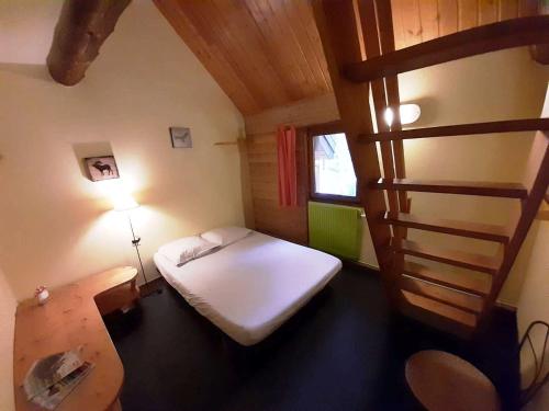 a small room with a bed and a ladder at Auberge Refuge de Roybon in Saint-Martin-en-Vercors