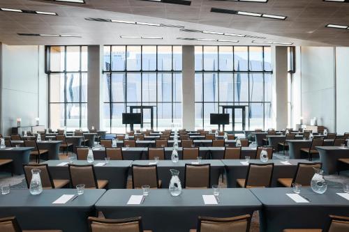 a large room with tables and chairs and windows at Kimpton Sawyer Hotel by IHG in Sacramento