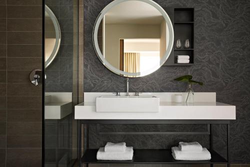 a bathroom with a sink and a mirror at Kimpton Sawyer Hotel by IHG in Sacramento