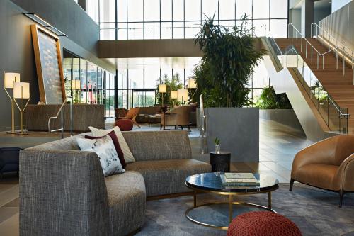 a lobby with a couch and chairs and a table at Kimpton Sawyer Hotel, an IHG Hotel in Sacramento