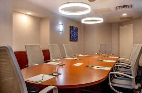 a conference room with a large wooden table and chairs at Holiday Inn Newport News - Hampton by IHG in Newport News