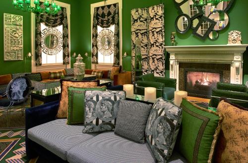 a living room with a couch and a fireplace at Kimpton Hotel Monaco Washington DC by IHG in Washington