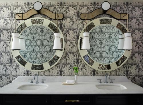 
a bathroom with two sinks and a mirror at Kimpton Hotel Monaco Washington DC, an IHG Hotel in Washington, D.C.
