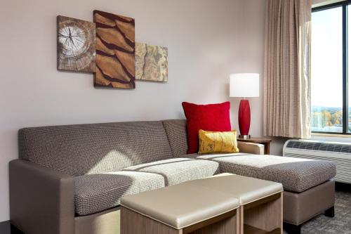 a living room with a couch and a table at Staybridge Suites Charlottesville Airport by IHG in Charlottesville