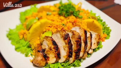 a plate of food with rice and meat and vegetables at Villa 252 Kosgoda in Kosgoda