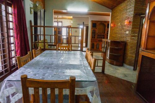 a dining room with a long table and chairs at Exotic Villa Homestay in Guwahati