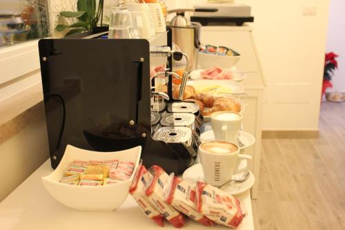 a counter with cups of coffee and some food at B&B Villa S.Anna in Bari