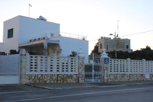 a white fence in front of a white house at B&B Villa S.Anna in Bari