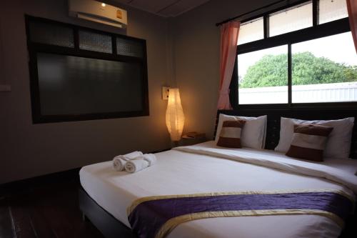 a bedroom with a large bed with towels on it at Marina hut guest house in Ko Lanta