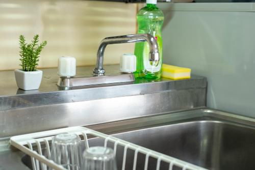 a kitchen sink with a faucet and a dish rack at 札幌市中心部大通公園まで徒歩十分観光移動に便利なロケーションh602 in Sapporo