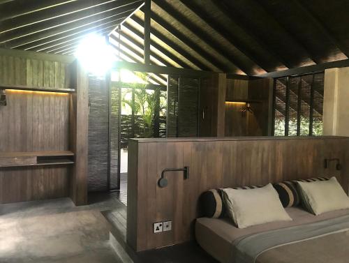 a bedroom with a bed in a room with windows at KAJU GREEN eco lodges in Unawatuna