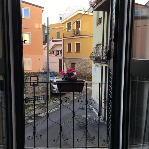 a view from a window of a balcony with a pot of flowers at La Casa di Marco in Nuoro