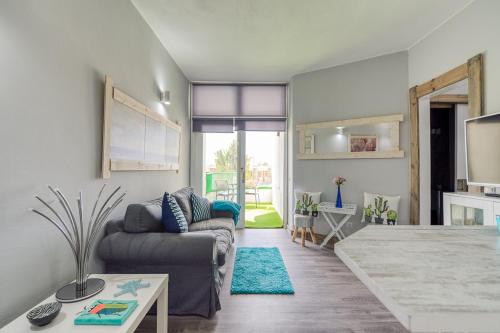 a living room with a couch and a table at Balcón Puerto Rico Playa Mogán in Mogán