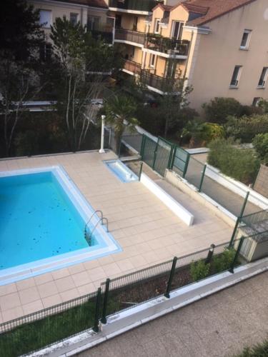 an overhead view of a swimming pool in a building at Near DISNEYLAND. Your location to enjoy holidays. in Bussy-Saint-Georges