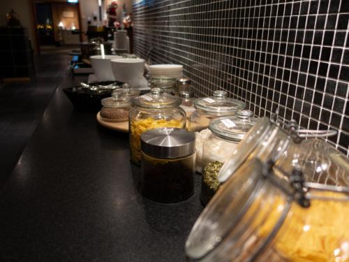 a counter with many jars of food on it at Hotell Toppen in Storuman