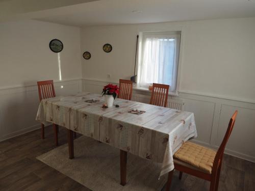 a dining room table with chairs and a white table cloth at KLEIN - Ferienhaus Thüringen Erfurt Apfelstädt Drei Gleichen in Apfelstädt