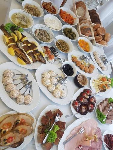 a table with many plates of food on it at Volter in Gdańsk
