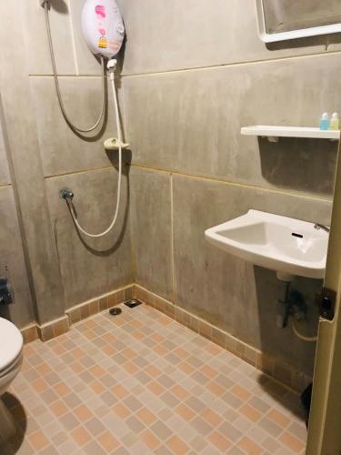 a bathroom with a shower and a toilet and a sink at Panutsaya Homestay in Wang Nam Khieo