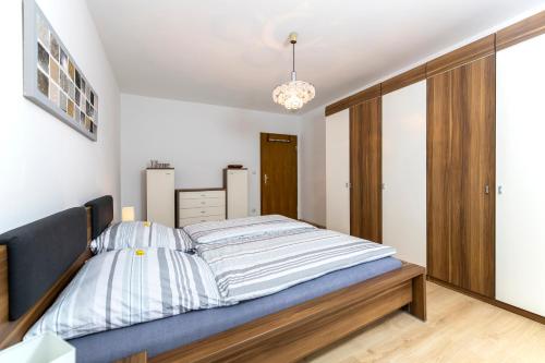 a bedroom with a large bed with a blue headboard at Andys Ferienwohnung in Neustadt an der Waldnaab