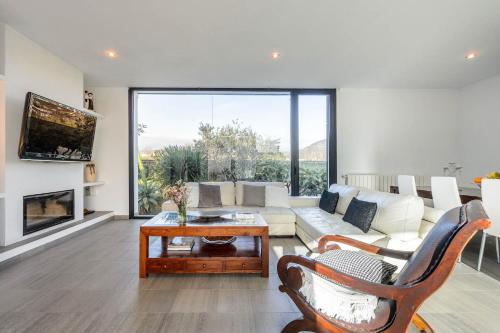 a living room with a couch and a fireplace at Villa Anur in Sant Josep de Sa Talaia