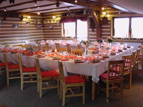 a dining room with a long table and chairs at Pension H in Jáchymov