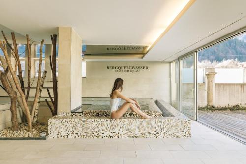 a woman sitting on the floor of a building at Hotel Goldener Ochs in Bad Ischl