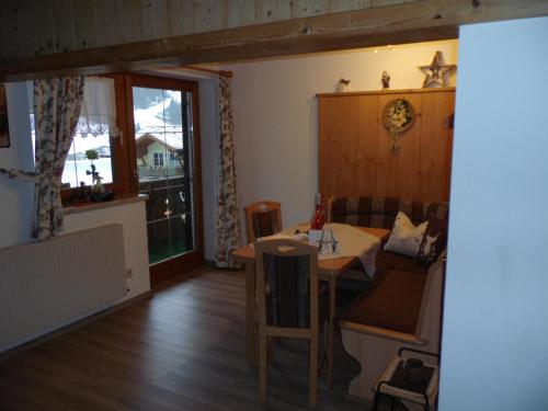 a living room with a table and a couch at Haus Monika in Nesselwängle