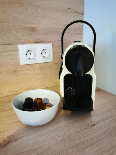 a toaster sitting on a table next to a bowl of chocolates at Am Millstättersee 35 in Döbriach