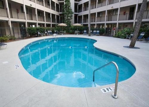 a large swimming pool in front of a building at Nothing But Ocean in Forest Beach in Hilton Head Island