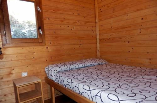 A bed or beds in a room at Camping Can Fosses
