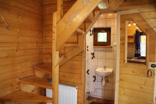 a bathroom with a staircase in a wooden house at Domek pod zielonym lasem in Zakopane