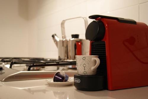 a coffee cup sitting on a counter next to a toaster at Ponte Rio in Pettorano sul Gizio