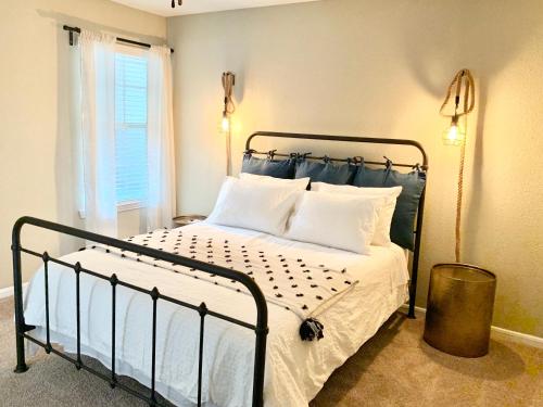a bedroom with a black bed with white pillows at Spacious 2BR&2BA Med Center APT, Free parking&shuttle in Houston