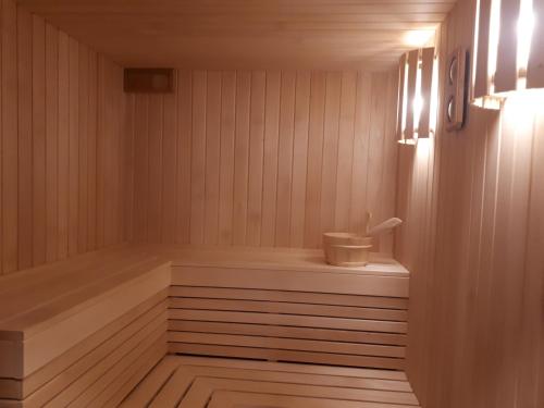 a sauna with a bench in a wooden room at Vila Valdonė in Palanga