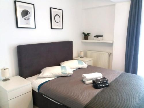 a bedroom with a bed with two towels on it at Airport Residence - Apartment across from Otopeni Airport in Otopeni