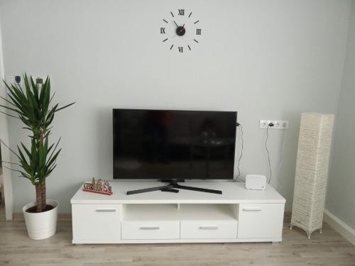 a white entertainment center with a flat screen tv on it at Our Haven in 1220 in Vienna