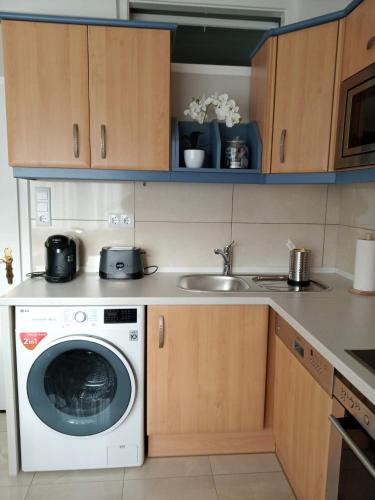 a kitchen with a washing machine and a sink at Our Haven in 1220 in Vienna