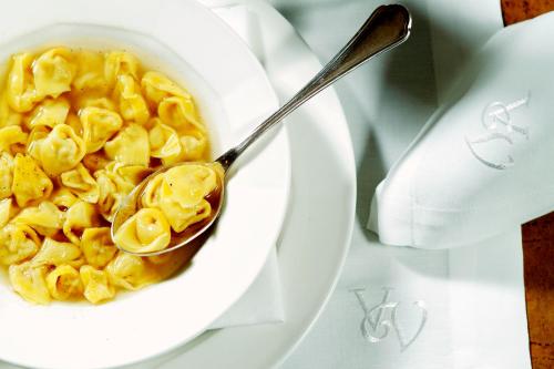 a bowl of macaroni and cheese with a spoon at Relais Villa Valfiore in San Lazzaro di Savena
