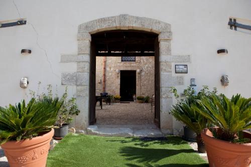 an entrance to a building with potted plants at Turismo Rurale Baglio Fastuchera in Alcamo