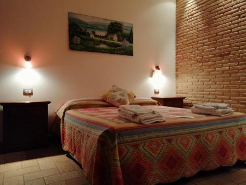 a bedroom with a bed with two towels on it at La Casa della Nonna in Brisighella