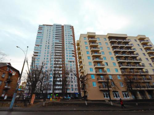 two tall apartment buildings next to each other at Сказочно волшебная квартира Соломенском районе Добробут in Kyiv
