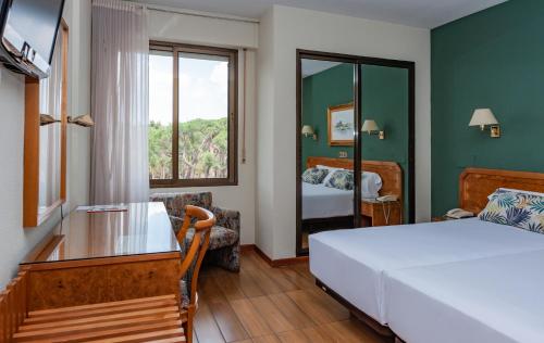 Postel nebo postele na pokoji v ubytování Hotel Don Carmelo