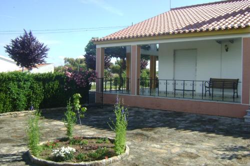 a house with a porch with a bench on it at Tapada da Beirã in Marvão